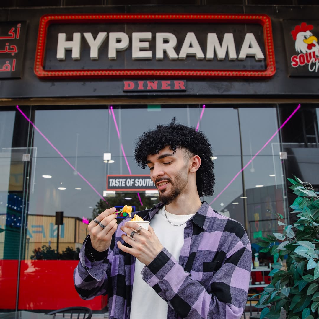 happy man eating ice cream infront of Hyperama Diner