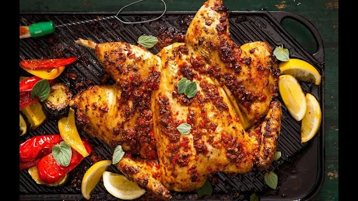Grilled peri peri chicken recipe with peri peri sauce, roasted vegetables and lemon