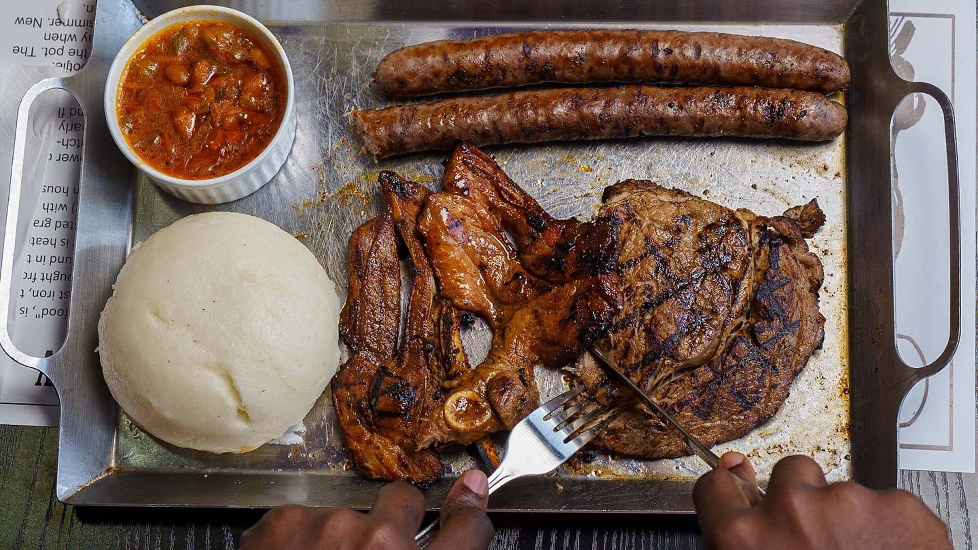 man eating south African steak with fork and knife